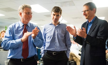 Washington Post reporter Eli Saslow, centre, is feted by Washington Post Executive Editor Marty Baron and editor David Finkel after the Pulitzers are announced in the newsroom April 2014. The Washington Post via Getty Images’s Eli Saslow won for explanatory writing and The Guardian US and The Washington Post via Getty Images (Barton Gellman) shared the honour for for Public Service.