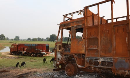 Burnt sand-carrying trucks lying by the ghat where sand mining took place near Jatpura village