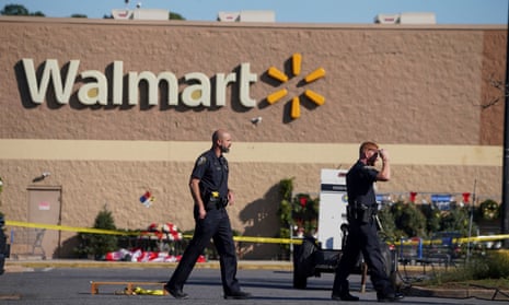Police walk through the parking lot after the mass shooting at a Walmart in Chesapeake, Virginia.