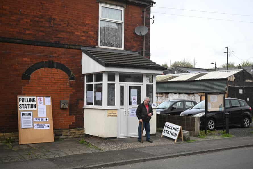 A voter leaving a polling station set up in the Heap Bridge social club, in Bury, today.