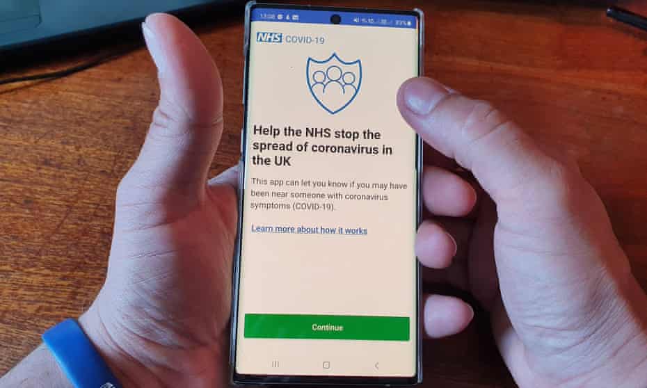 A resident of the Isle of Wight poses with his smartphone showing the NHS coronavirus contact-tracing app