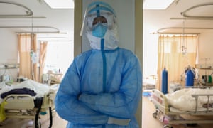 A nurse rests against a wall near coronavirus patients at a hospital in Wuhan.