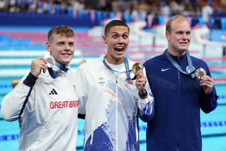 Matthew Richards (left) with his silver medal but it was David Popovici (centre) of Romania who took the gold