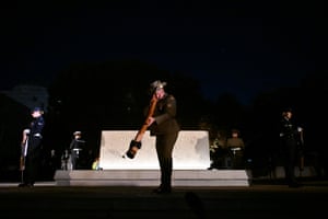 A man plays a didgeridoo as dawn service is held at the Australian War Memorial in Canberra.