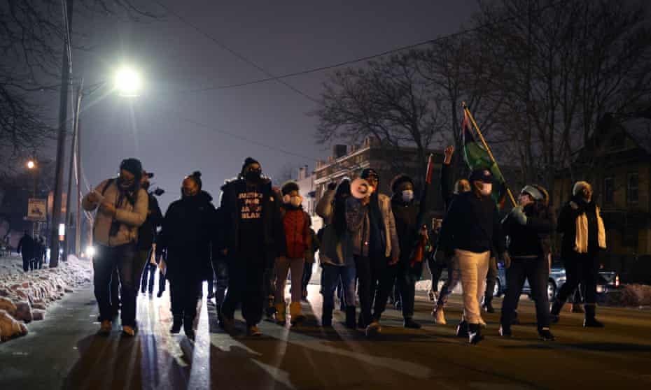 Demonstrators march on Tuesday in Kenosha, Wisconsin following the announcement that no charges would be filed against the police officer who shot Jacob Blake. 