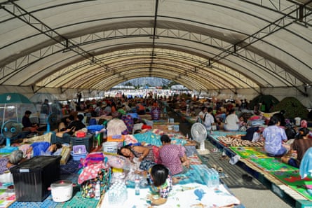People rest at a shelter after the latest military clashes between Thailand and Cambodia.