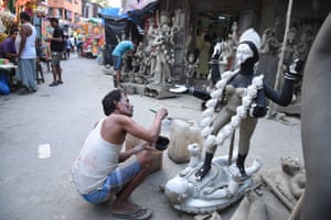 An artist paints an idol