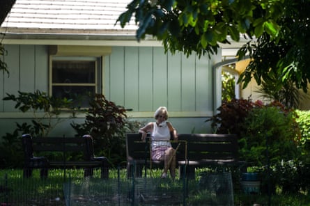 An older woman sits in the garden of John Knox Village, a retirement community in Pompano Beach, Florida.