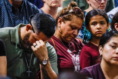 People mourn during a community gathering at the Uvadle County Fairplex.