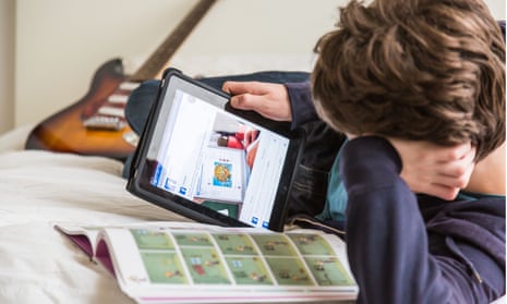 Teenage boy on tablet looking at Facebook
