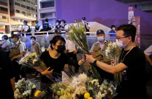 Protesters lay flowers near the Prince Edward MTR station, in Mongkok, where police clashed with protesters last year. Some believe demonstrators were killed in the station, an allegation authorities have denied.