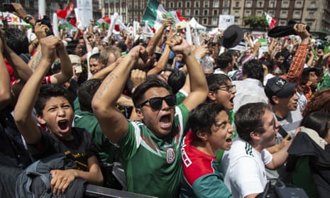 Fans watch the Mexico vs. Germany World Cup soccer match at an outdoor screen in Mexico City.