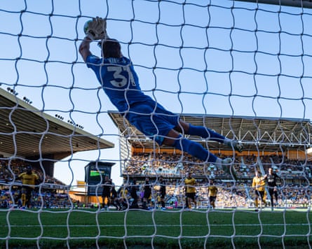 Antonin Kinsky makes a diving save to keep out João Gomes’s free-kick during the Premier League match between Wolverhampton Wanderers and Tottenham Hotspur