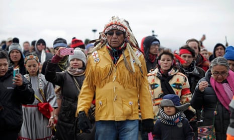 Chief Arvol Looking Horse, spiritual leader of the Sioux nation, leads his people to peacefully pray near a law enforcement barricade just outside of a Dakota Access pipeline construction site.