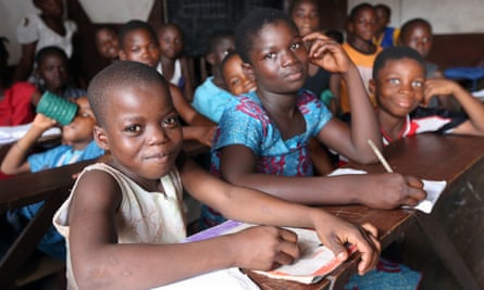 Schoolchildren sitting at desks in a classroom