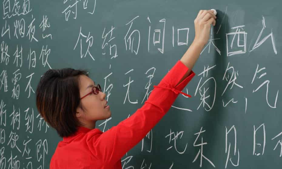 woman writing chinese characters on chalk