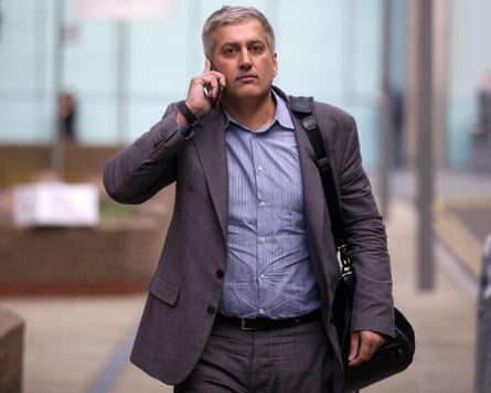 Jay Merchant on the phone as he leaves Southwark crown court in London during his trial in 2016.