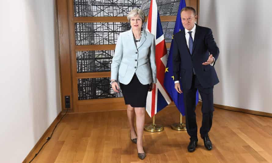 Theresa May and Donald Tusk leave after posing for photographers in Brussels after reaching a deal on 8 December 2017.