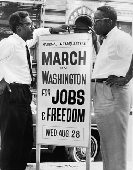 Black and white picture of Bayard Rustin and Cleveland Robinson with a sign between them reading ‘march on washington for jobs and freedom’