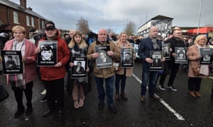 Family members of Bloody Sunday victims make their way to the Guildhall in Derry on 14 March.