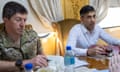 Gen Gwyn Jenkins sitting at a table next to Rishi Sunak in a plush train carriage