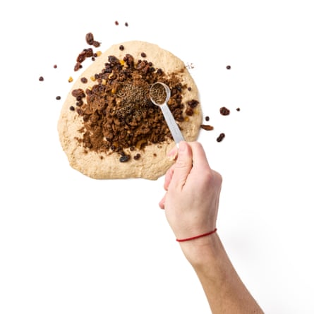 Felicity Cloake’s bara brith 03b. Tipping out the dough on to a clean surface, pressing it down flat, then tipping the fruit and spices all over the top.