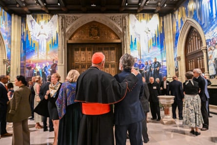 a group of people observing a mural in a church