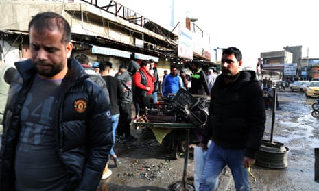 Iraqis gather at the site of the suicide bomb attacks at Tayran Square in central Baghdad.