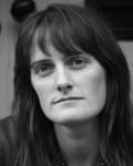 Aideen Malone, with long dark hair and fringe, looks directly at the camera