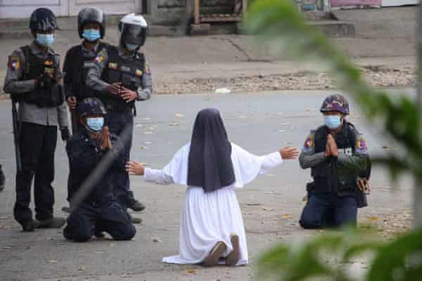A num pleading with police in Myanmar