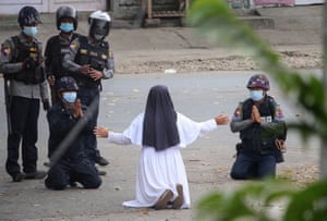 A nun pleads with police not to harm protesters in Myanmar