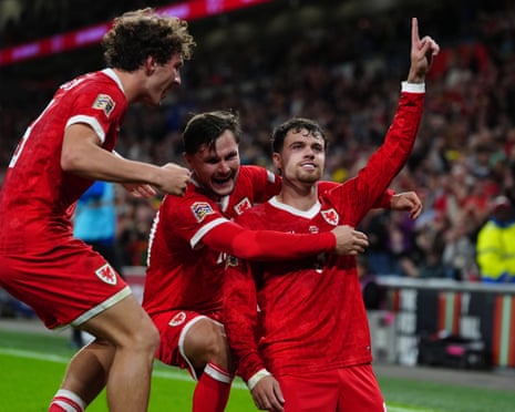 Wales' Neco Williams (right) celebrates scoring their side's second goal of the game.