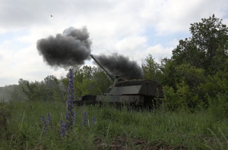 Ukrainian servicemen fire a self-propelled howitzer towards Russian positions at the front line near Bakhmut