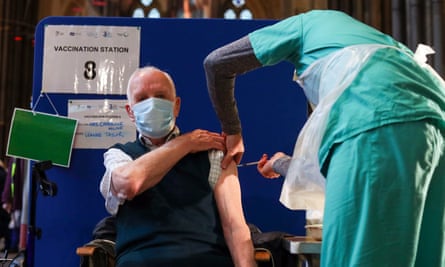 Louis Godwin receives an injection of the Pfizer coronavirus vaccine at Salisbury Cathedral.