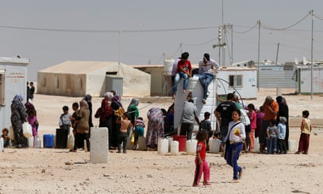 Syrian refugees collect water at the Za’atari refugee camp in Mafraq, Jordan.