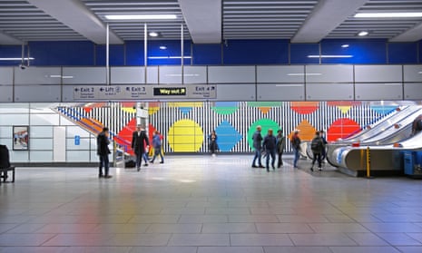 The Eastern ticket hall at Tottenham Court Road underground station shows wall artwork by Daniel Buren.