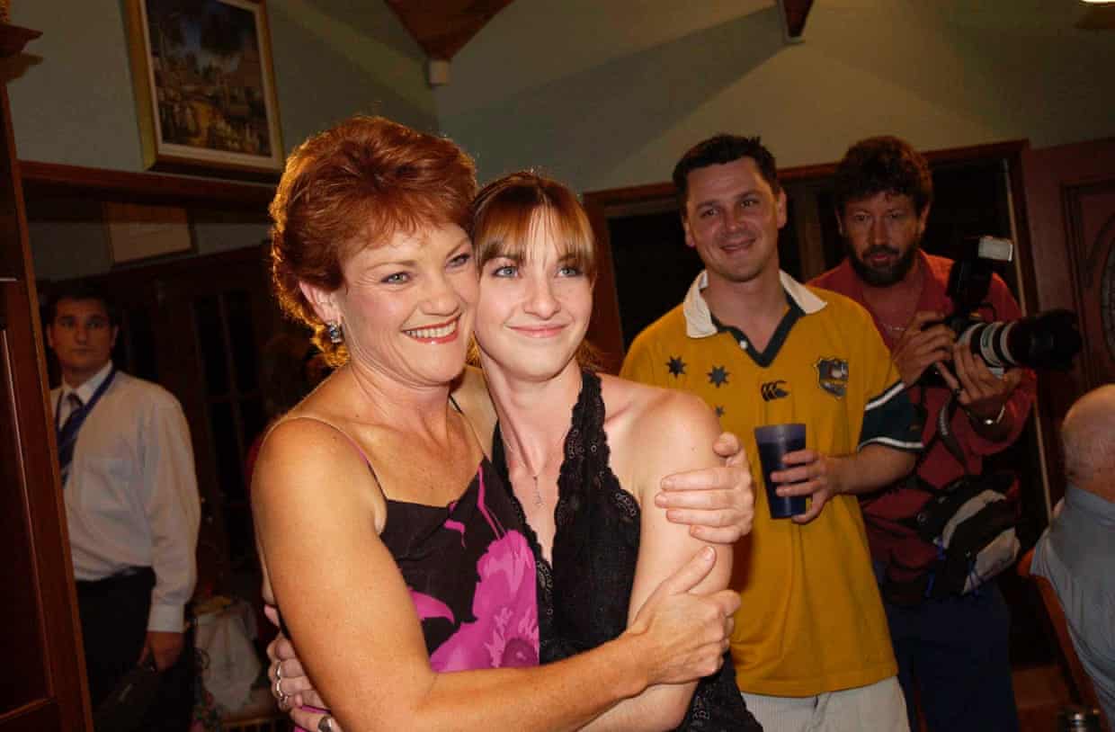 Hanson hugs her daughter as her son, holding a beer, looks on