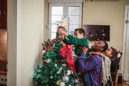 Family decorating a Christmas tree