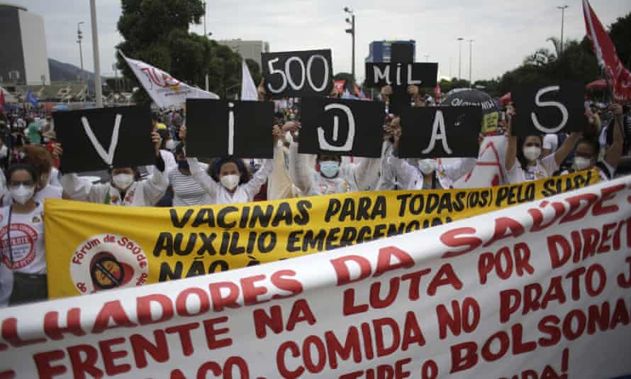 Women hold up placards with a message that reads in Portuguese; “500K deaths! His fault!” during a demonstration against Brazilian President Jair Bolsonaro’s handling of the coronavirus pandemic and economic policies protesters say harm the interests of the poor and working class, in Rio de Janeiro, Brazil. Brazil is approaching an official COVID-19 death toll of 500,000 — second-highest in the world.