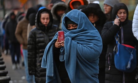 Newly arrived migrants line up outside the immigration services building on Federal Plaza, in lower Manhattan. States far from the border are dealing with the effects of irregular migration.