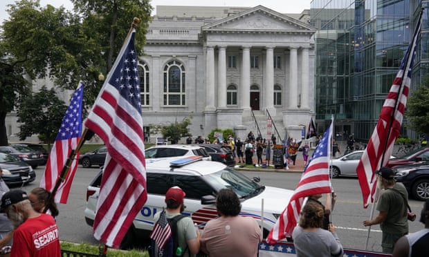 les gens agitent des drapeaux à l'extérieur du bâtiment à DC