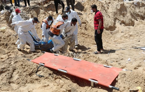 People work yesterday to move into a cemetery bodies of Palestinians killed during Israel's military offensive and buried at Nasser hospital, in Khan Younis.
