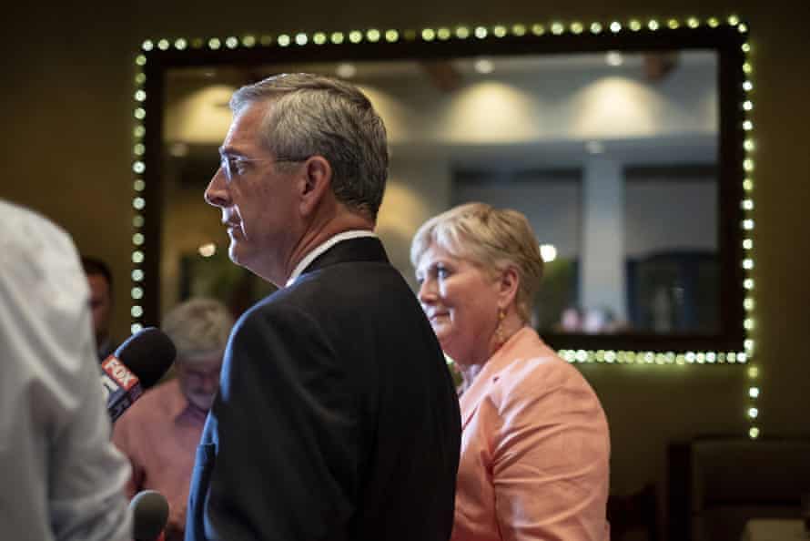 Brad Raffensperger walks through a crowd of supporters.