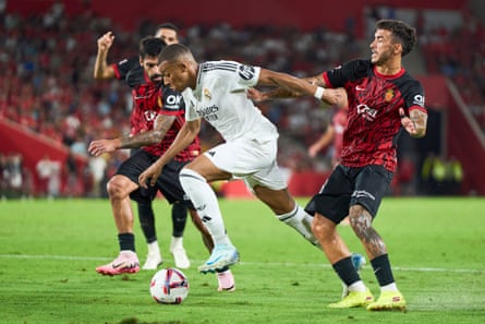 Kylian Mbappé of Real Madrid and Mallorca’s Antonio Sánchez compete for the ball during the La Liga match in 2024.