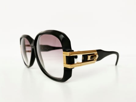 black-framed glasses with big lenses and gold color on the side