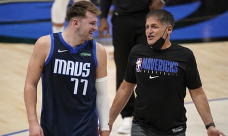 Dallas Mavericks point guard Luka Doncic, left, with the team’s owner, Mark Cuban, walk off the court after winning against the Detroit Pistons in 2021.