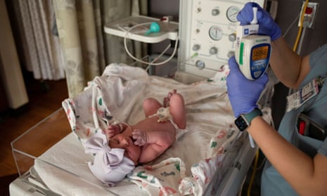 A nurse checks the vitals of a newborn baby in Royal Oak, Michigan