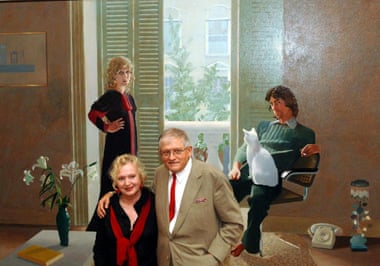 David Hockney stands in front of his painting Mr and Mrs Clark and Percy with Celia Birtwell