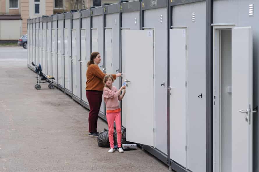 Ukrainian refugees enter accomodation in Lviv.