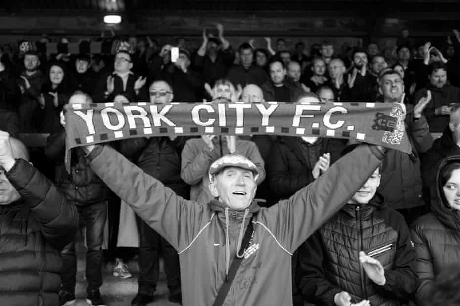 Goodbye Bootham Crescent: the end of an era for York City | York City 8 A fan holds a scarf aloft